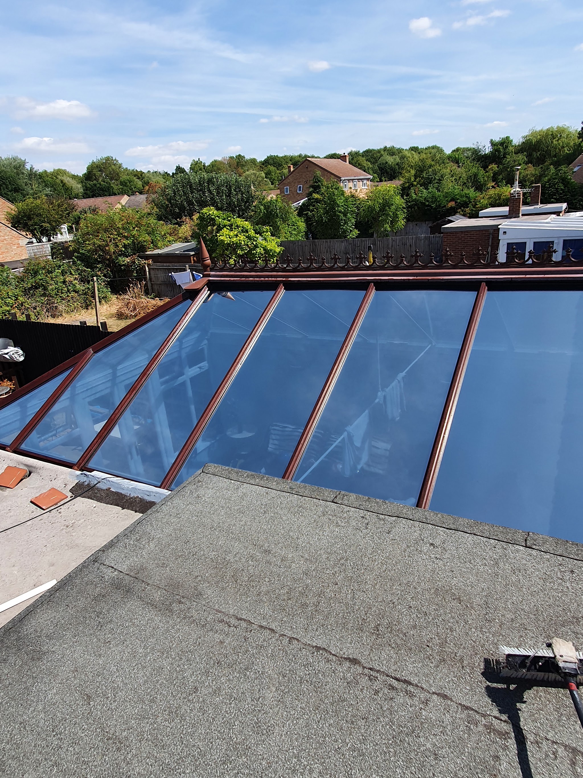 A cleaned glass lantern roof shining under a blue sky