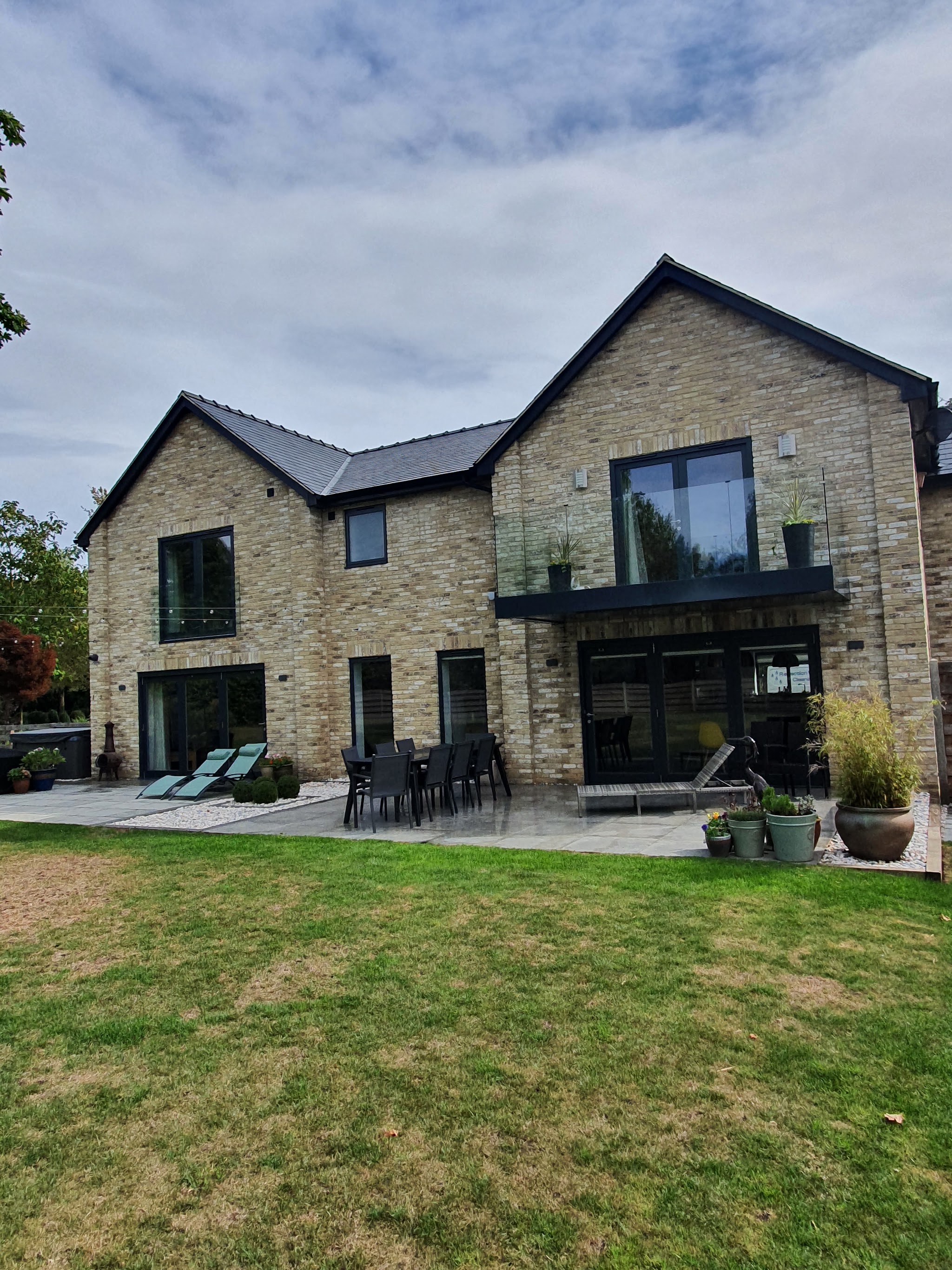 A large modern stone house with big panes of glass